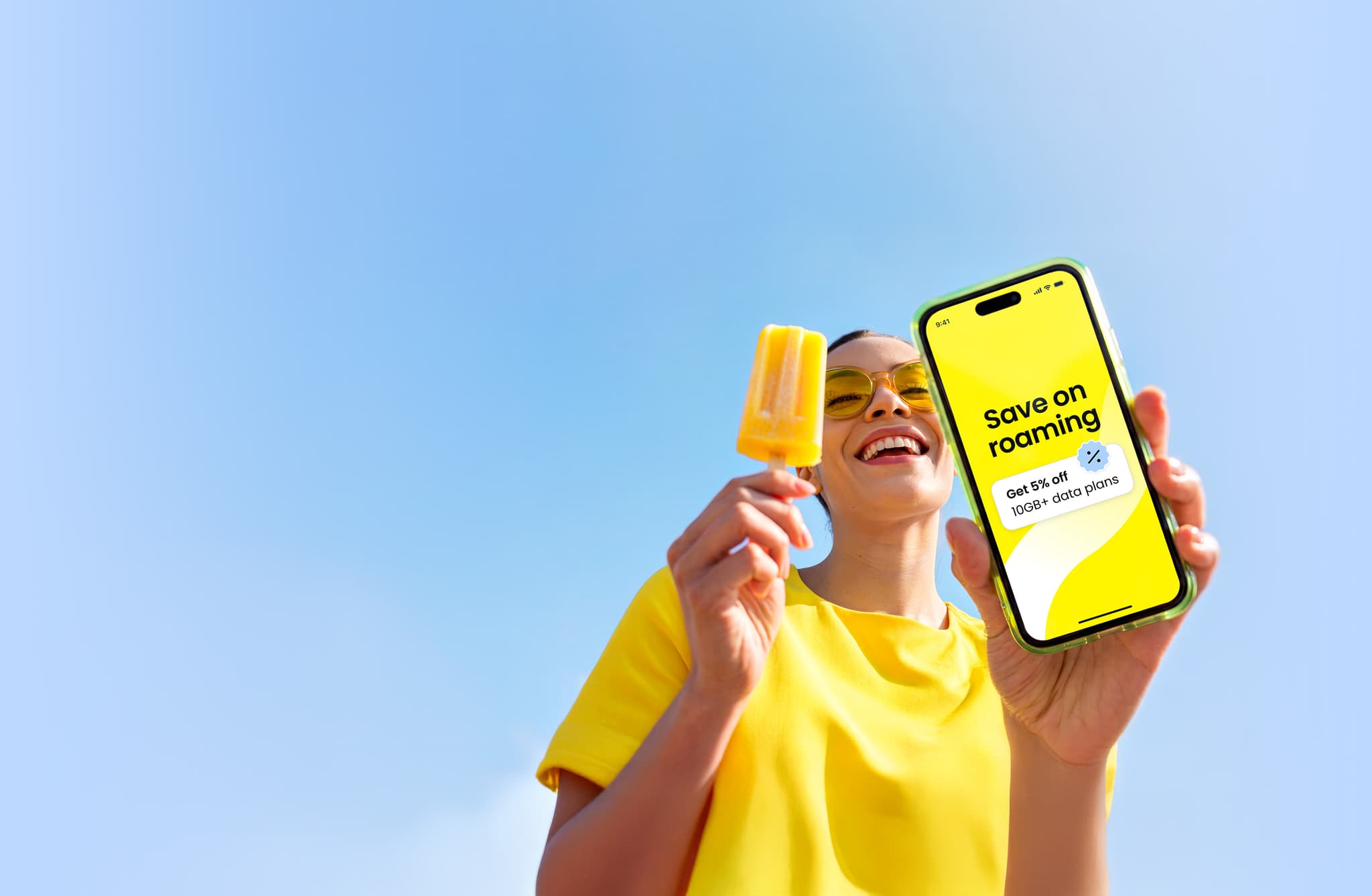 A woman using the Saily eSIM app on her phone to save on roaming costs while traveling.