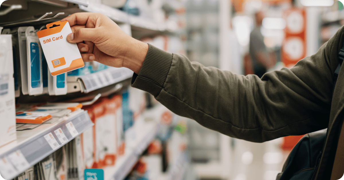 A person picking up a SIM card at the aisle of a supermarket