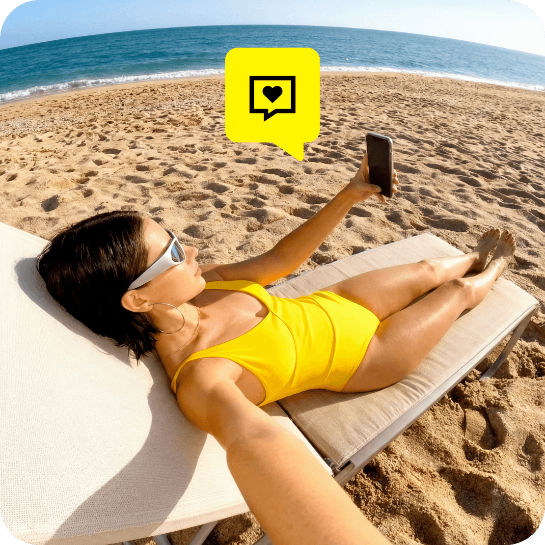 A woman lying on a beach towel and taking a selfie. A “Comment” icon overlay.