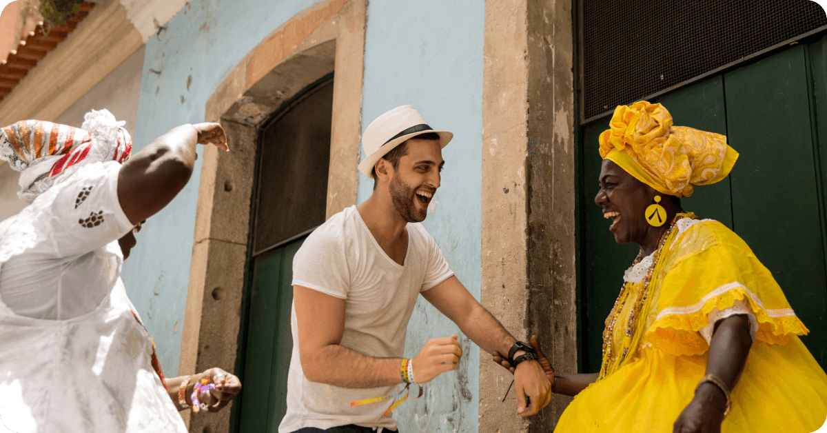 A tourist chatting with locals on the street in Brazil, using their Portuguese language skills.