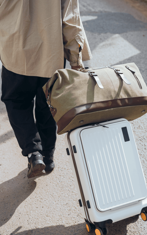 Business traveler pulling luggage at an airport