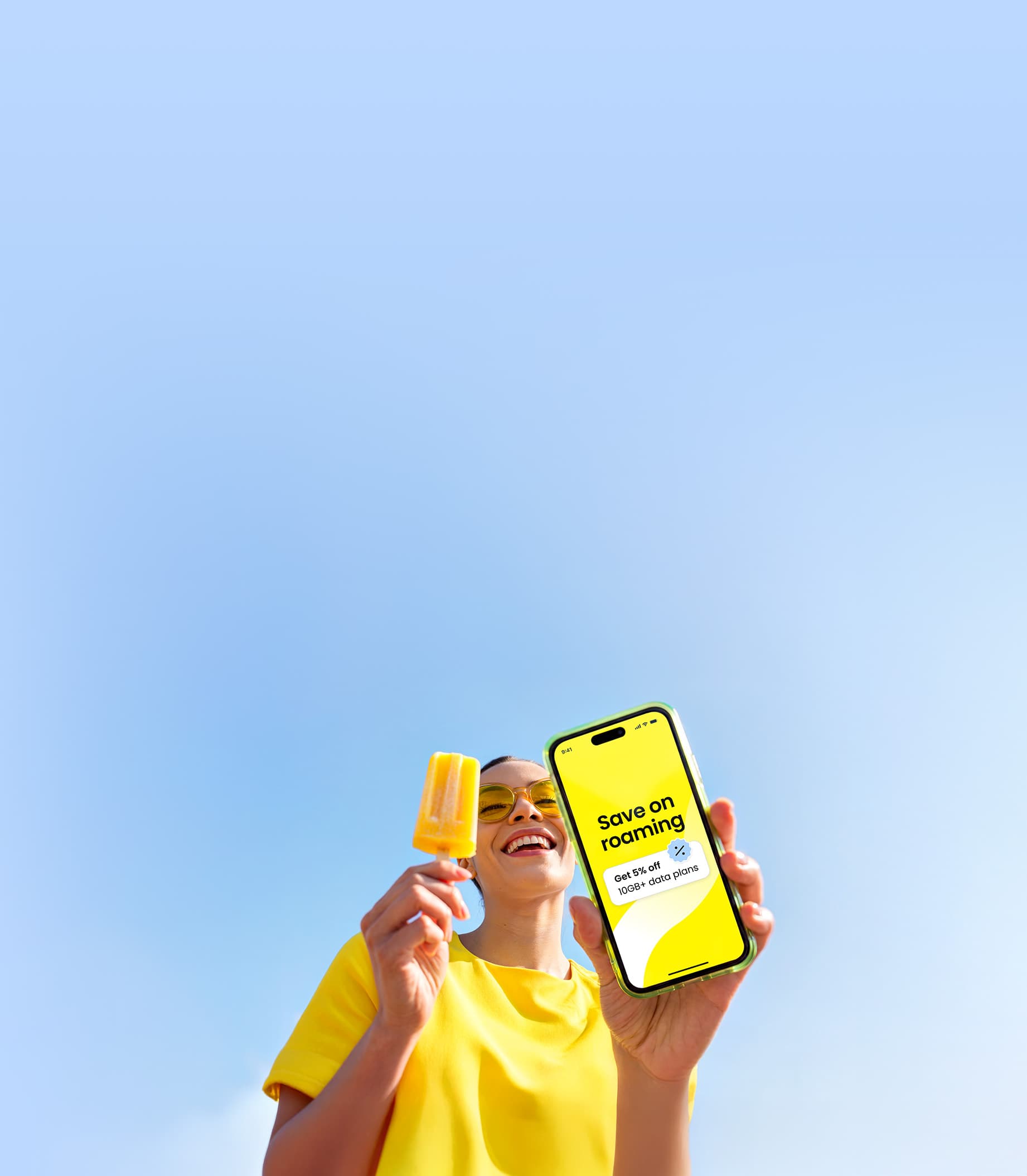 A woman using the Saily eSIM app on her phone to save on roaming costs while traveling.