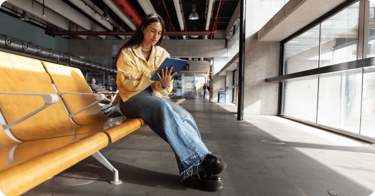 Young women is using eSIM mobile data in an airport during a layover.