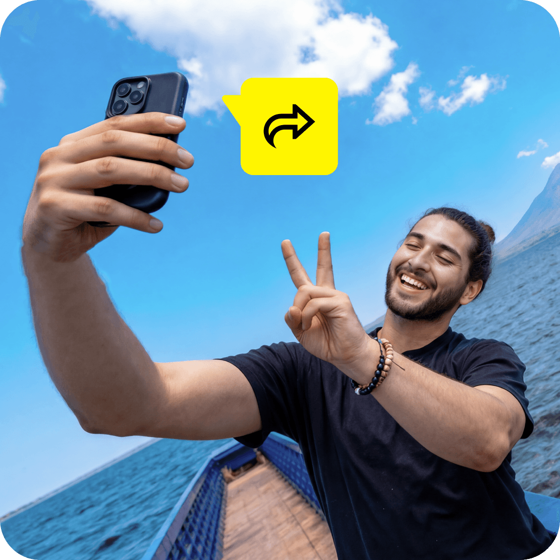 A man taking a selfie while traveling with a backpack, with blue sky and cliffs behind him. A “Share” icon overlay.