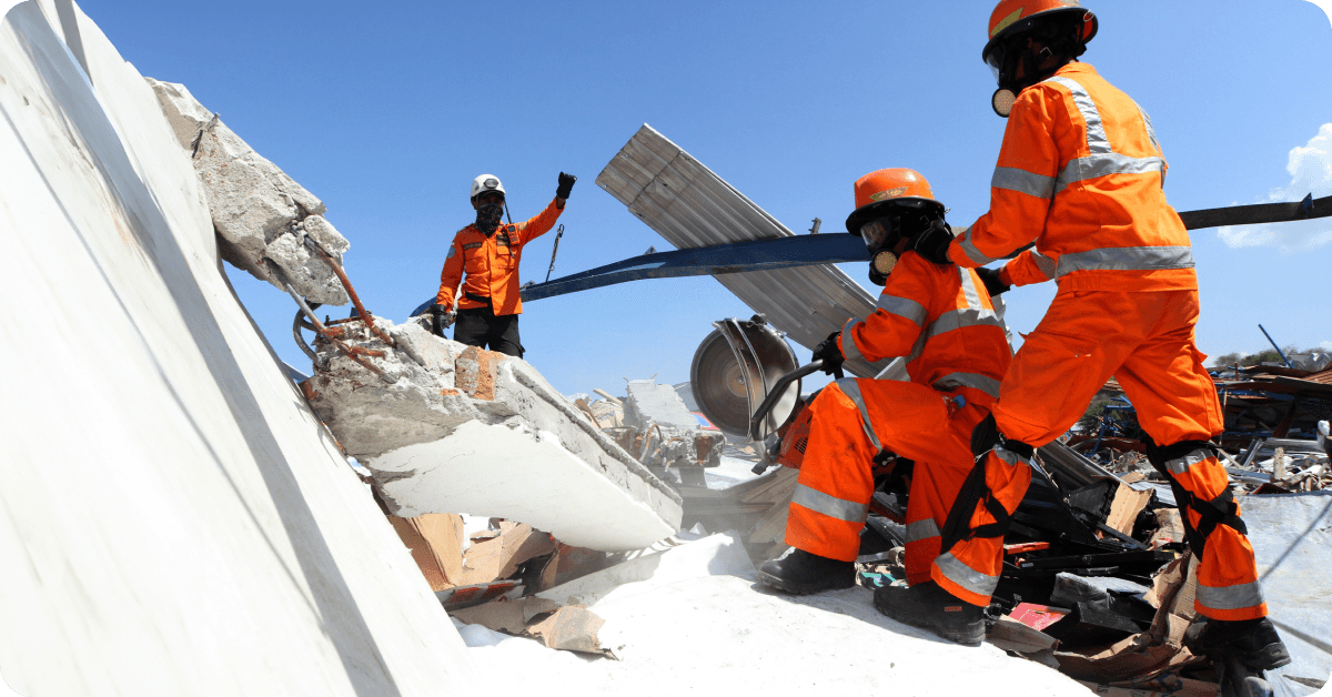 Emergency personnel clearing rubble after an earthquake