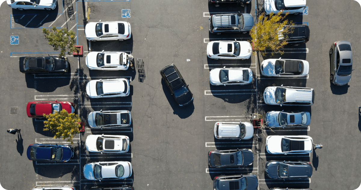 An overhead view of a parking lot with cars.