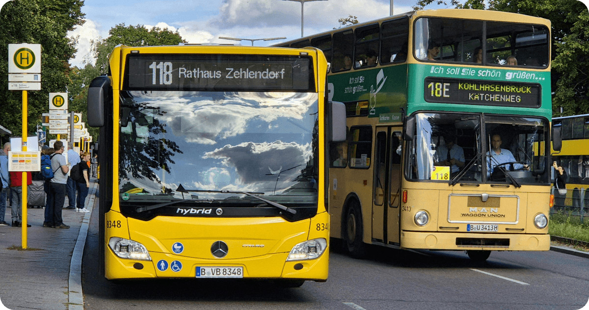 Two buses depart from a bus stop in Berlin.