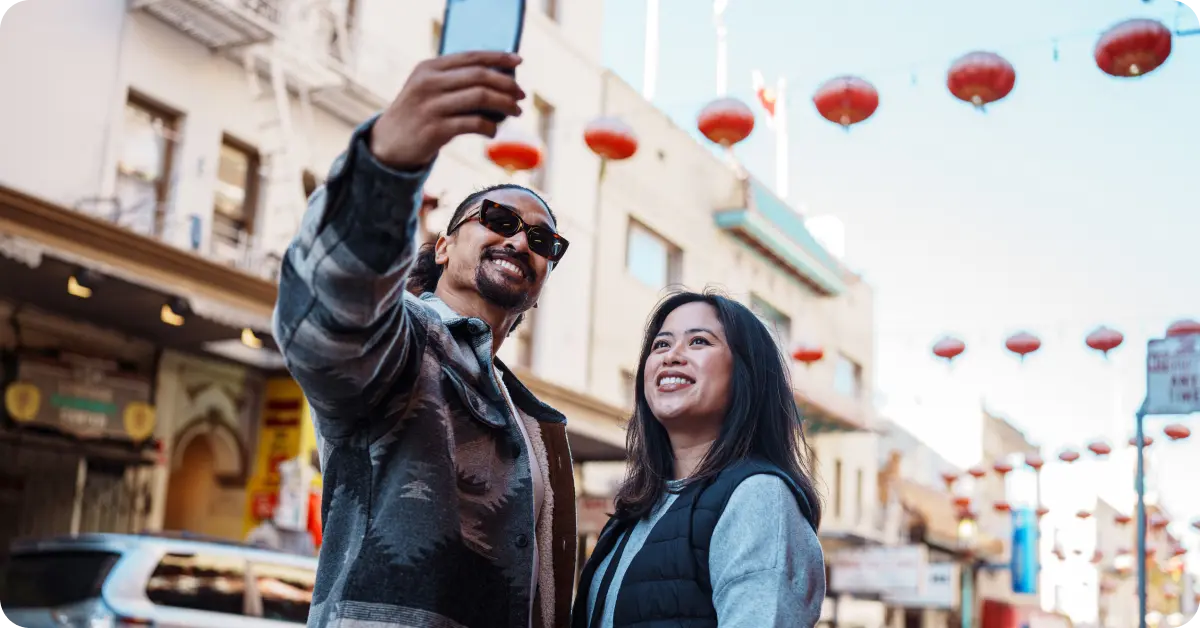 A couple taking a selfie in San Francisco's Chinatown