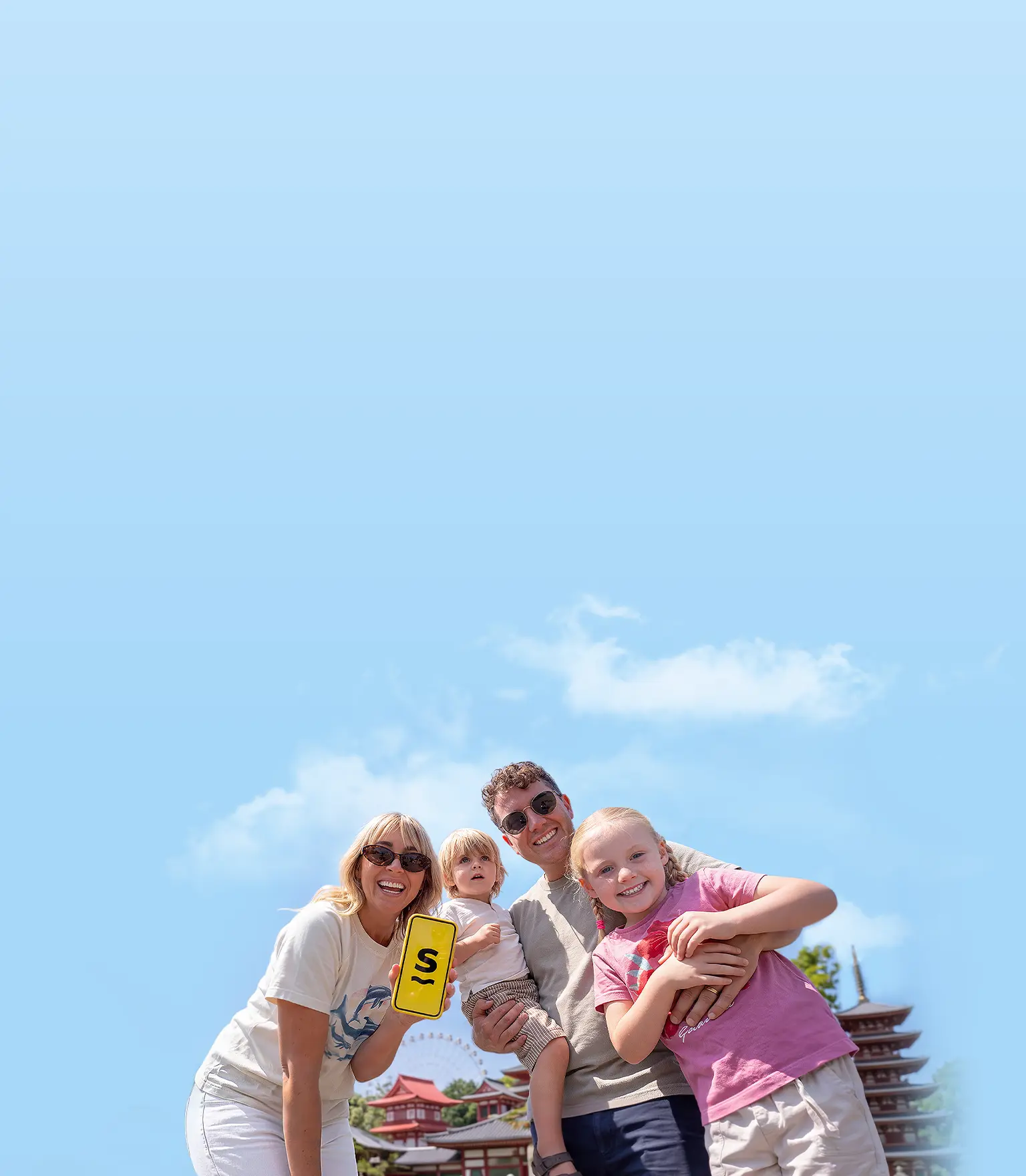 The “Flying the Nest” family holding up a phone displaying the Saily eSIM app logo.
