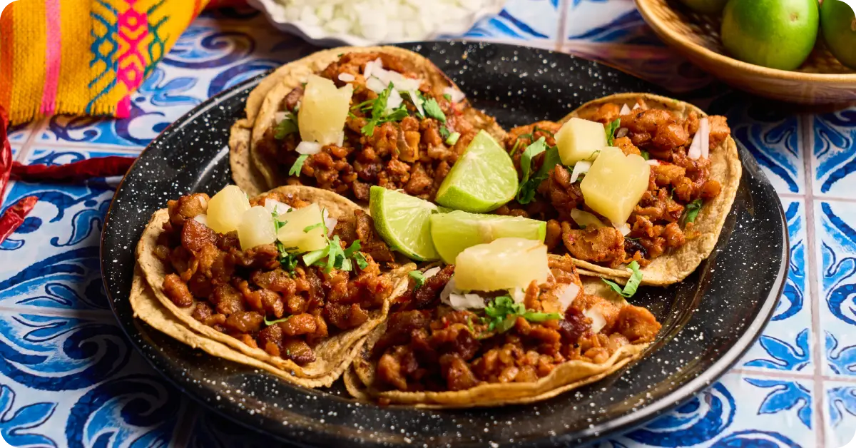 Close-up of tacos al pastor being sliced.