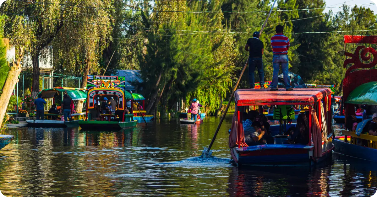 Families on colorful trajineras in Xochimilco.