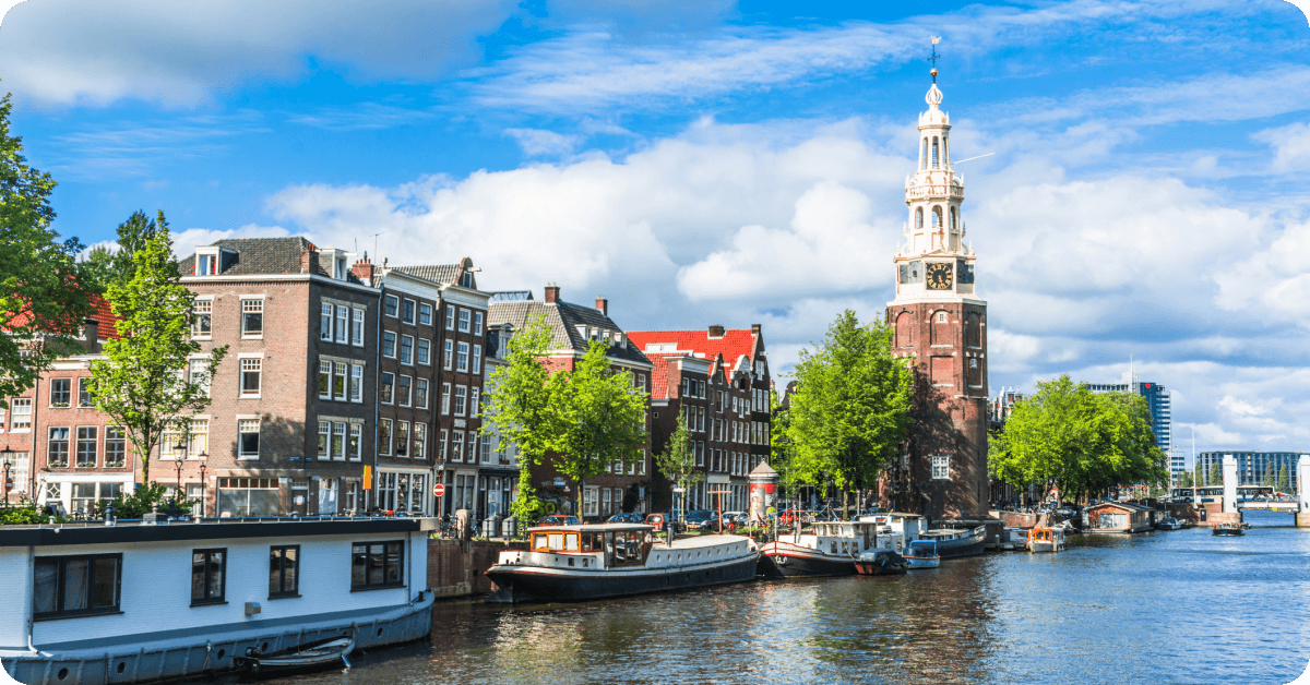 A view of the Montelbaanstoren tower situated along the Oudeschans canal in Amsterdam, Netherlands.