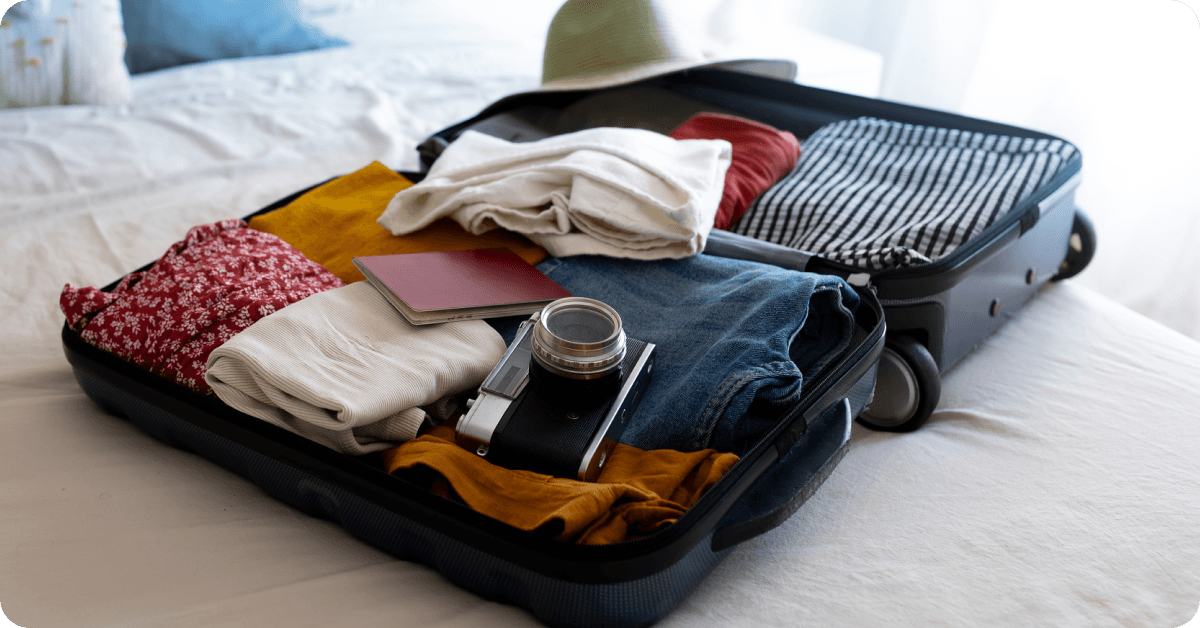 A suitcase is being packed for an upcoming flight.
