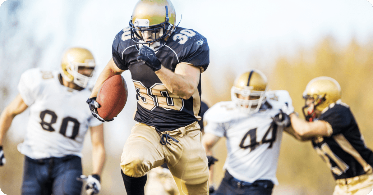 An American footballer runs with the ball.