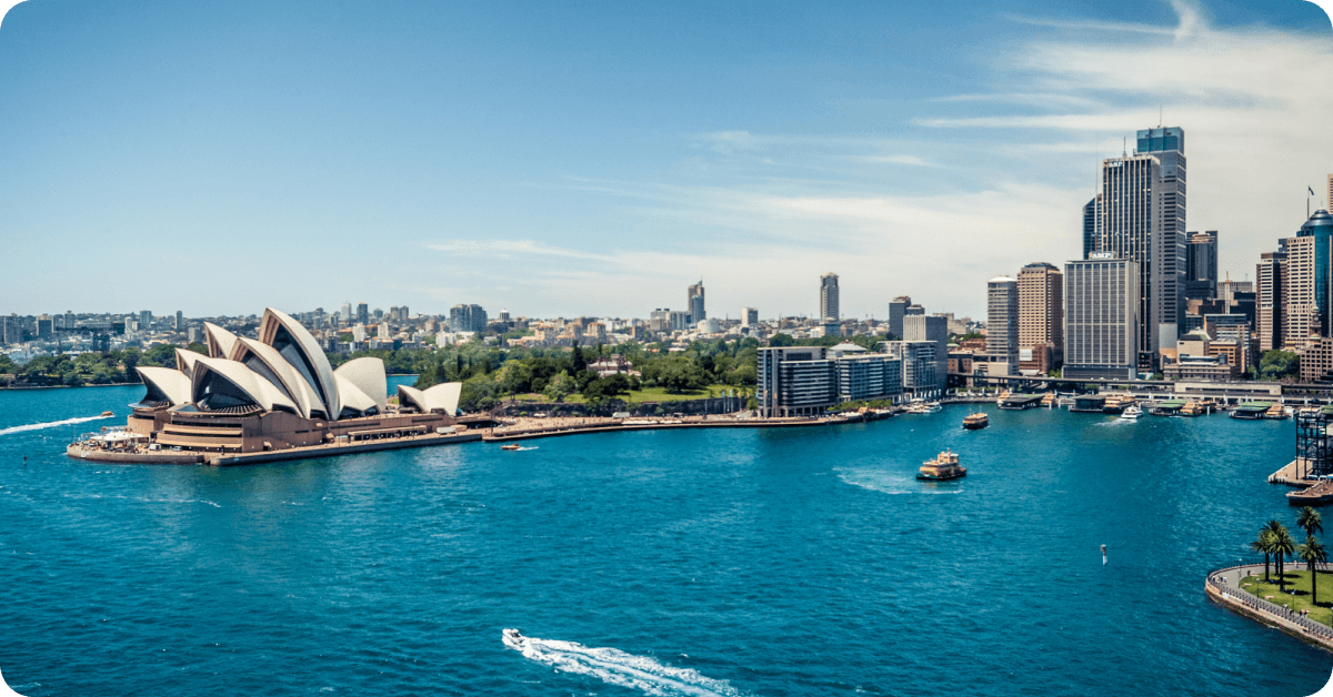 A panoramic view of the iconic Sydney Opera House and the surrounding Sydney Harbour in Australia.