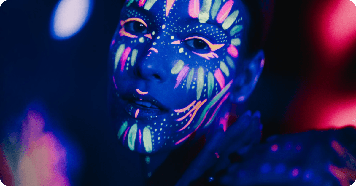 A face painted with neon paint.