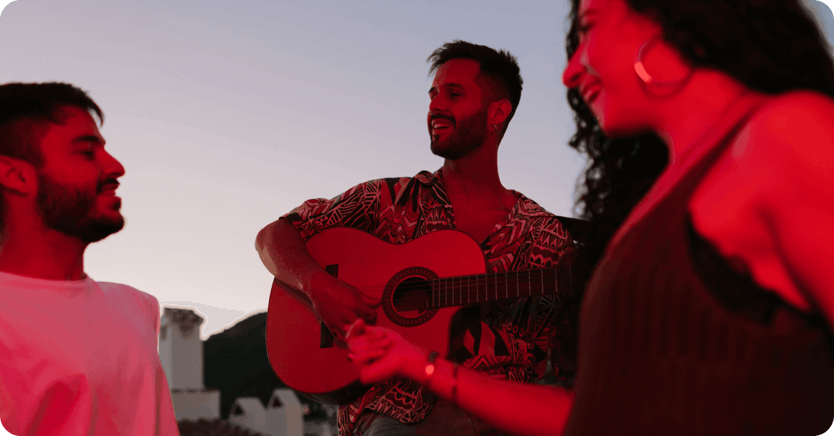 People at night playing a guitar and singing